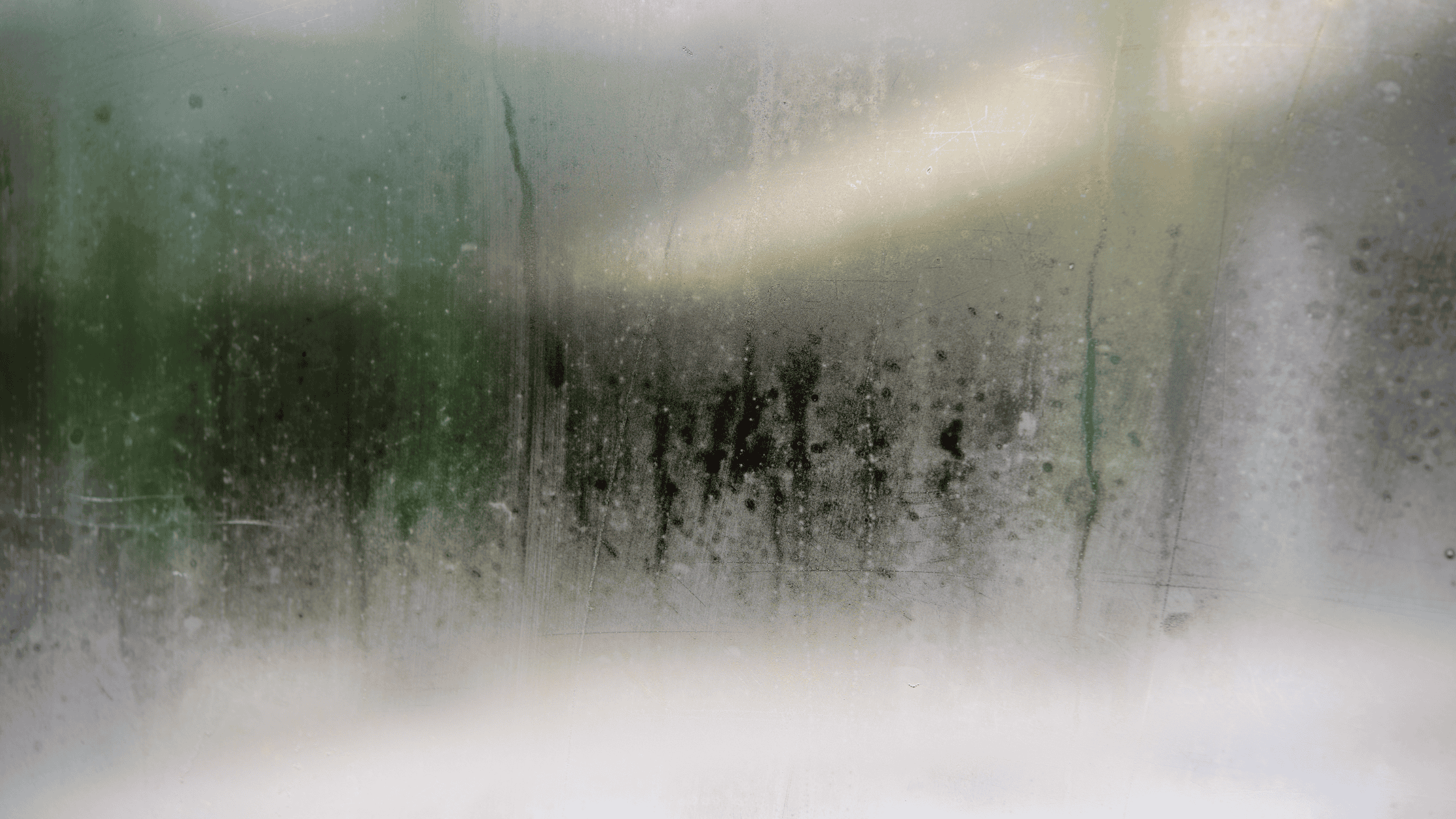 a blurry image of a window covered in condensation from the indoor humidity